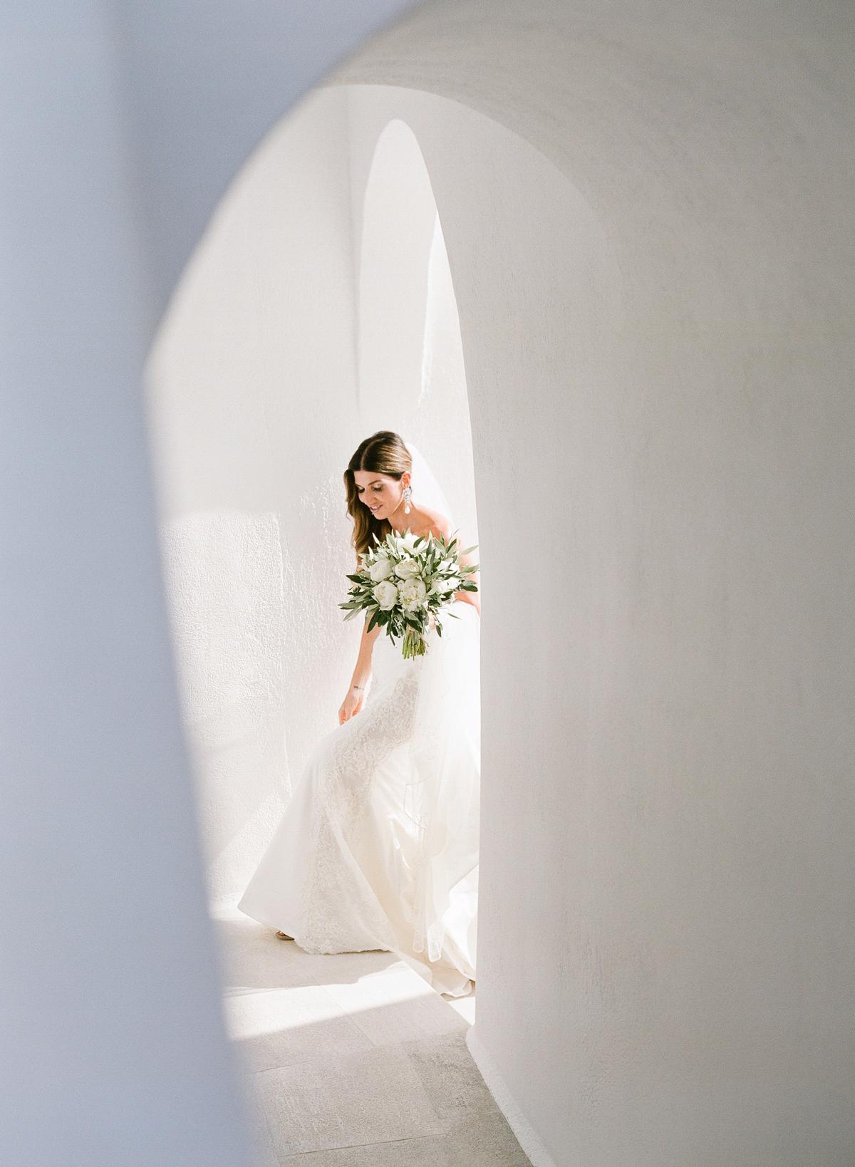 bride approaching her first look in Santorini