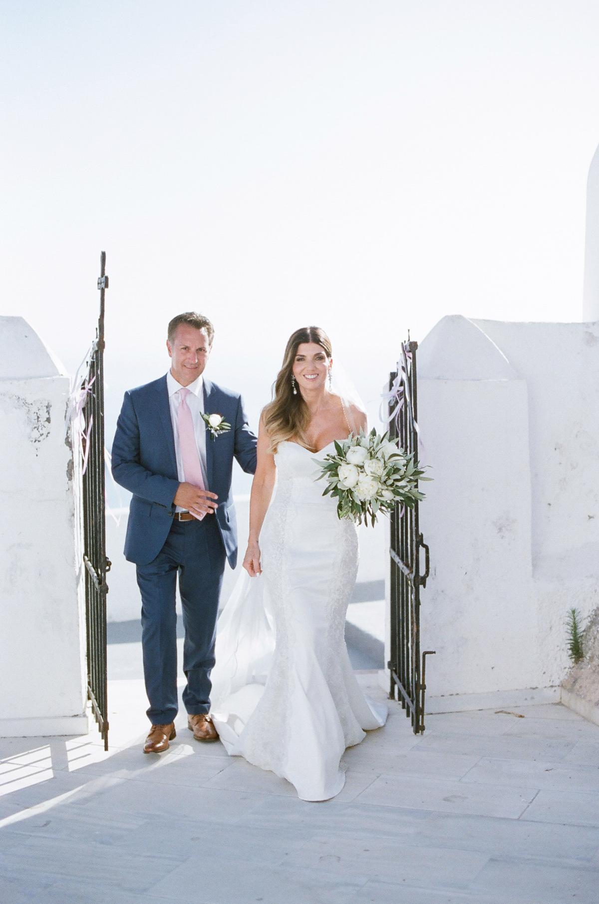 bride and groom entering church in Santorini