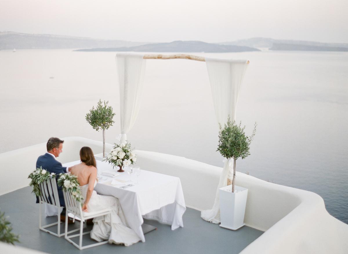 couple overlooking Aegean sea during elopement in Santorini