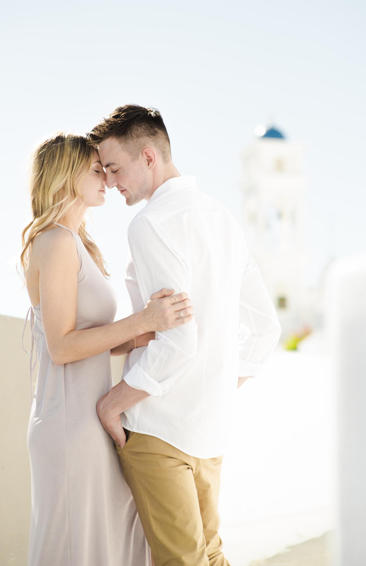 couple during engagement session at the blue domes in oia santorini