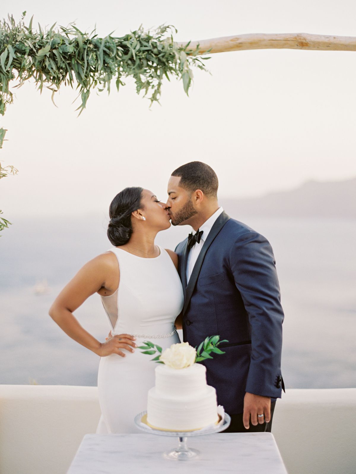 Portrait of bride and groom at Canaves Oia, Santorini during cutting cake