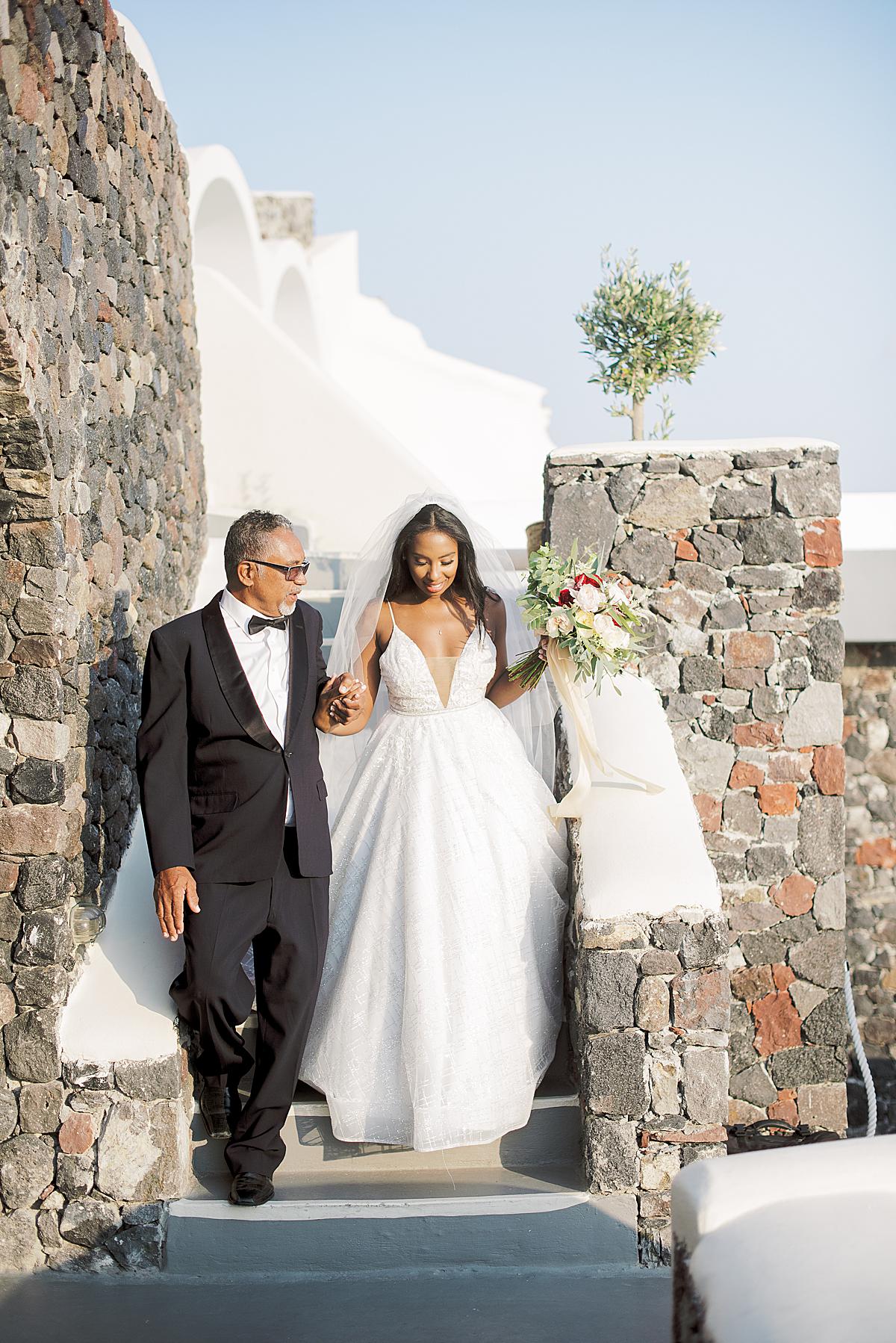 bride and her father entering Canaves Oia Santorini