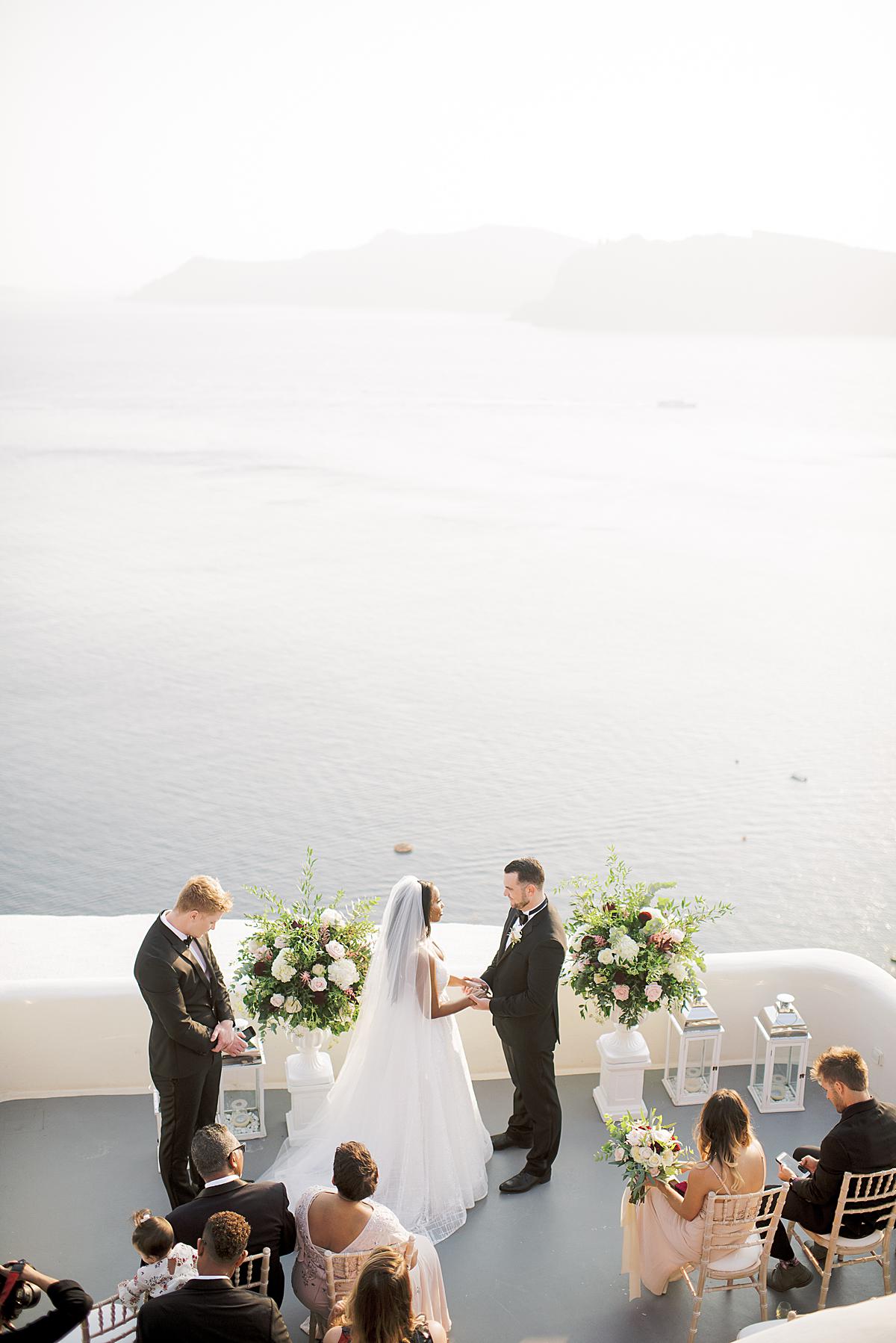 Bride and groom during their ceremony at Canaves Oia Santorini
