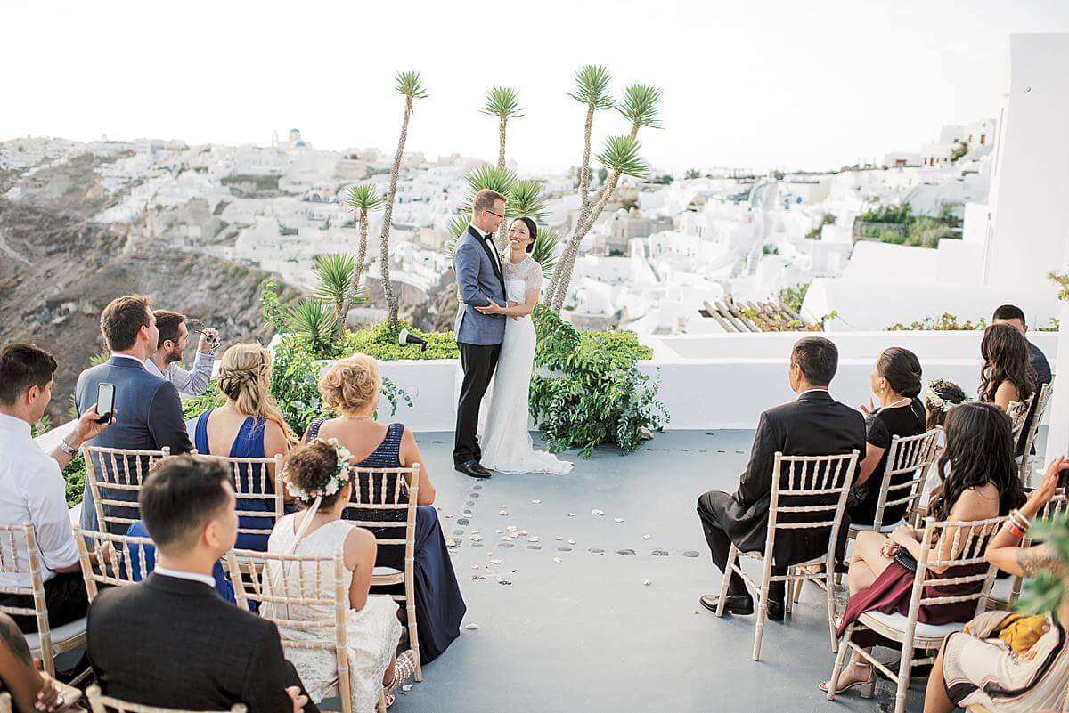 bride and groom embracing during wedding ceremony at Ikies Santorini