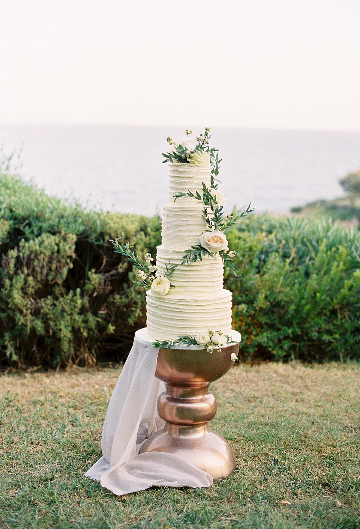 four tier white colored destination wedding cake for a wedding at the athens riviera