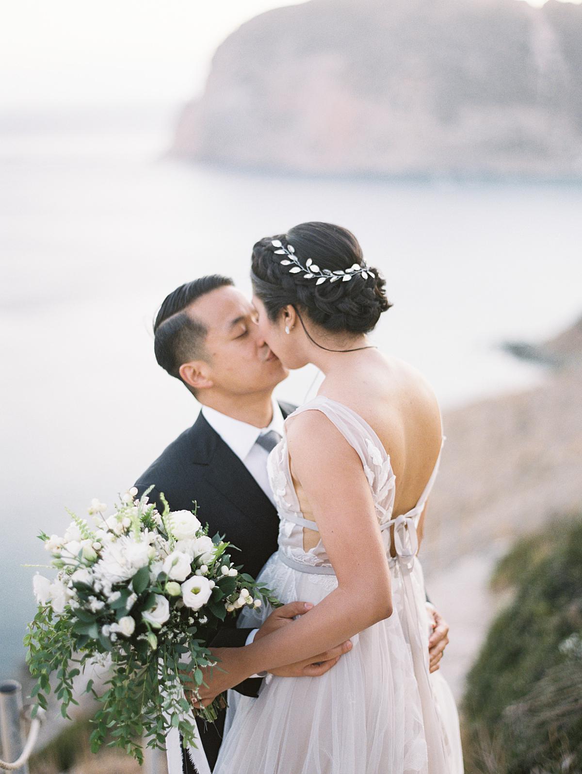 Bride and Groom kissing each other at Milos wedding in Greece