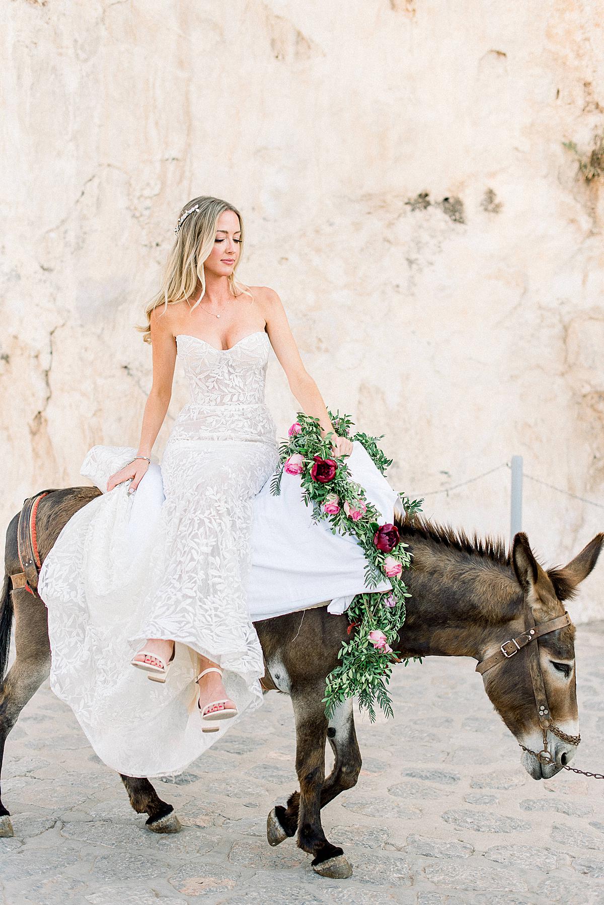 bride on donkey and her dad on her way to ceremony at hydra destination wedding_1
