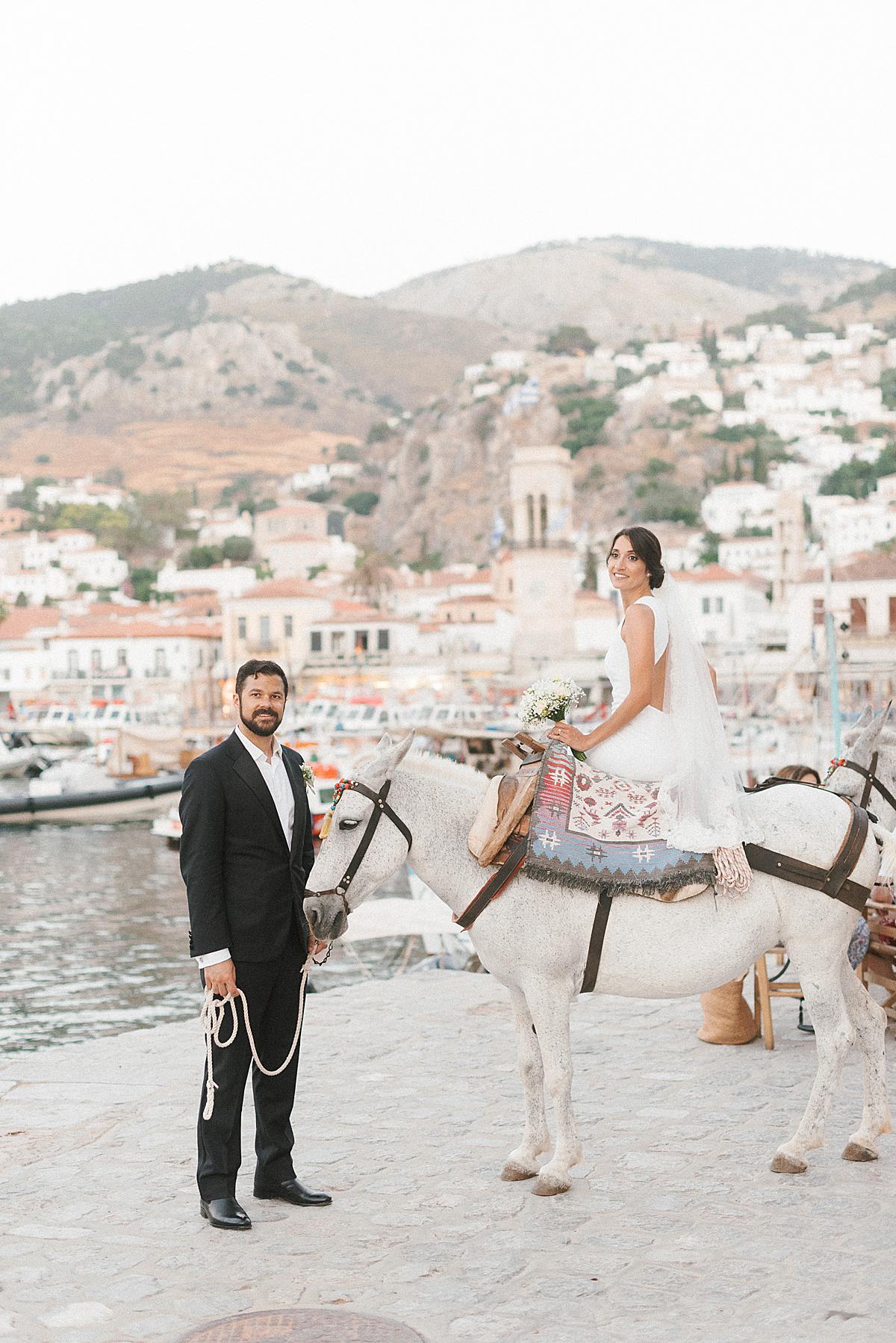 groom and bride on donkey on hydra wedding
