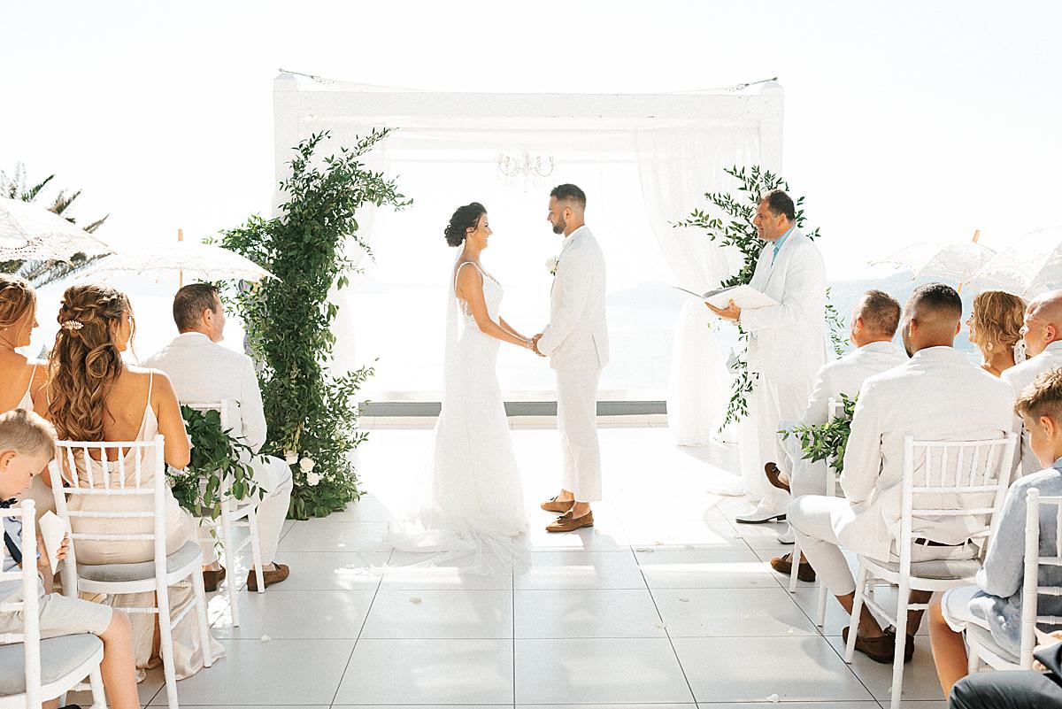 bride and groom during ceremony at santorini wedding