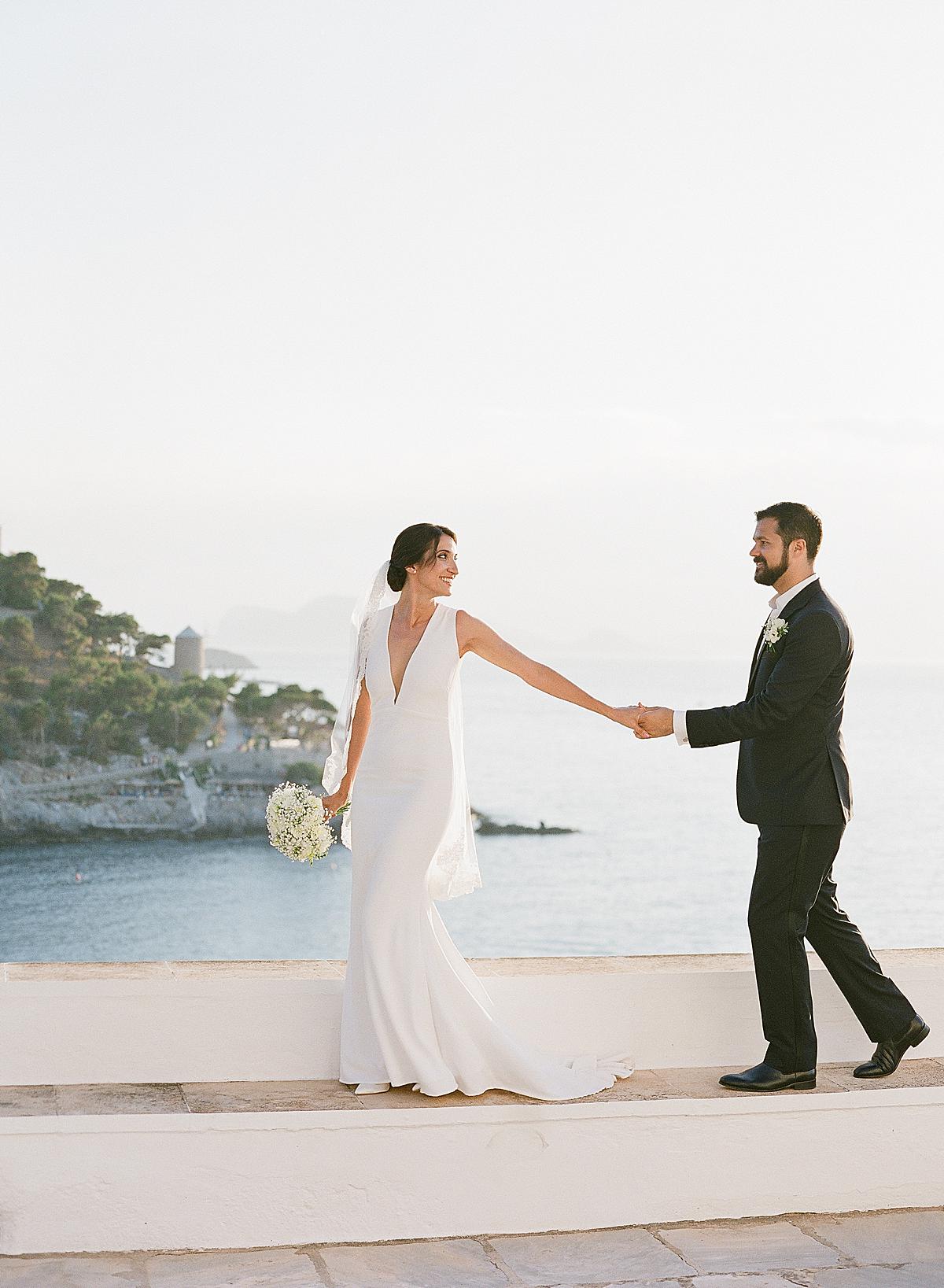 bride and groom portrait overlooking hydra harbour