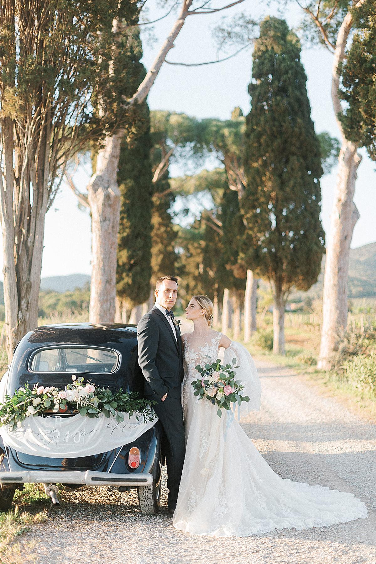 bride and groom portraits at L'Andna in Tuscany with old car
