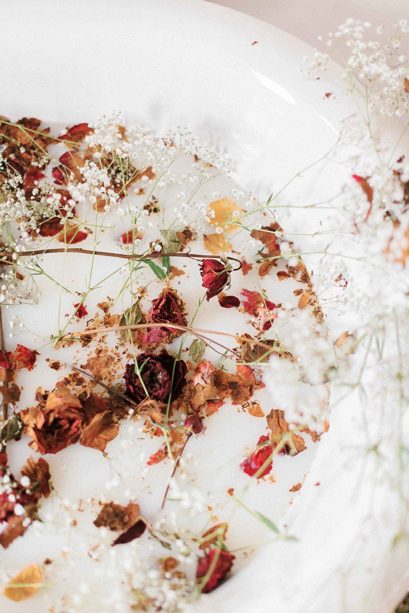 dried flowers in a bathtub for a bridal boudoir session