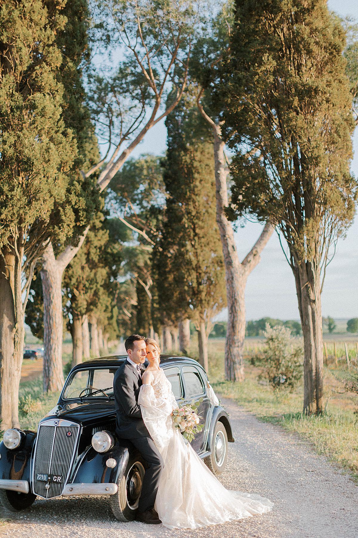 bride and groom portraits at L'Andna in Tuscany with old car