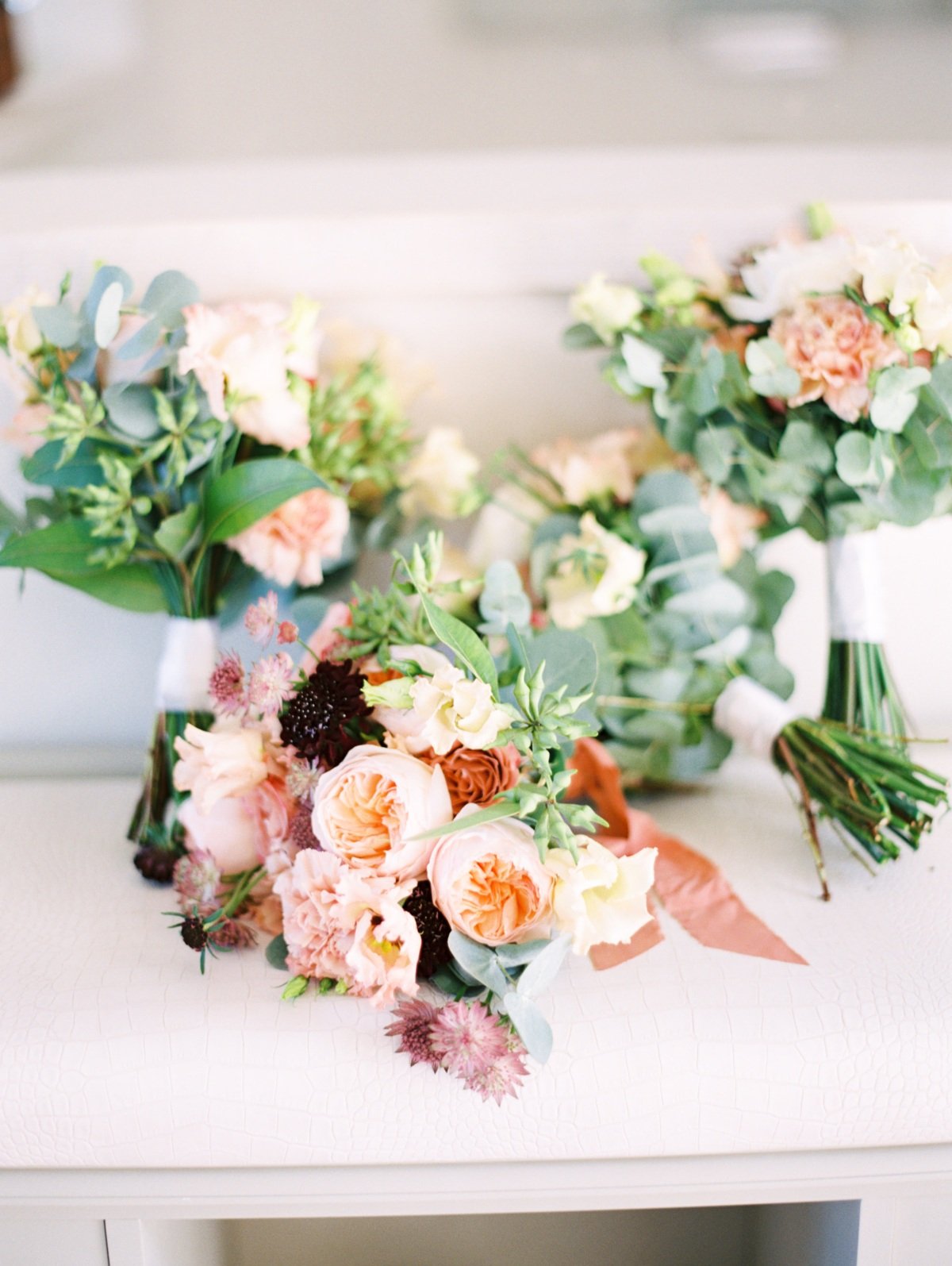 beautiful wedding bouquets in shades of pink and coral for a destination wedding in greece by les anagnoy photographers