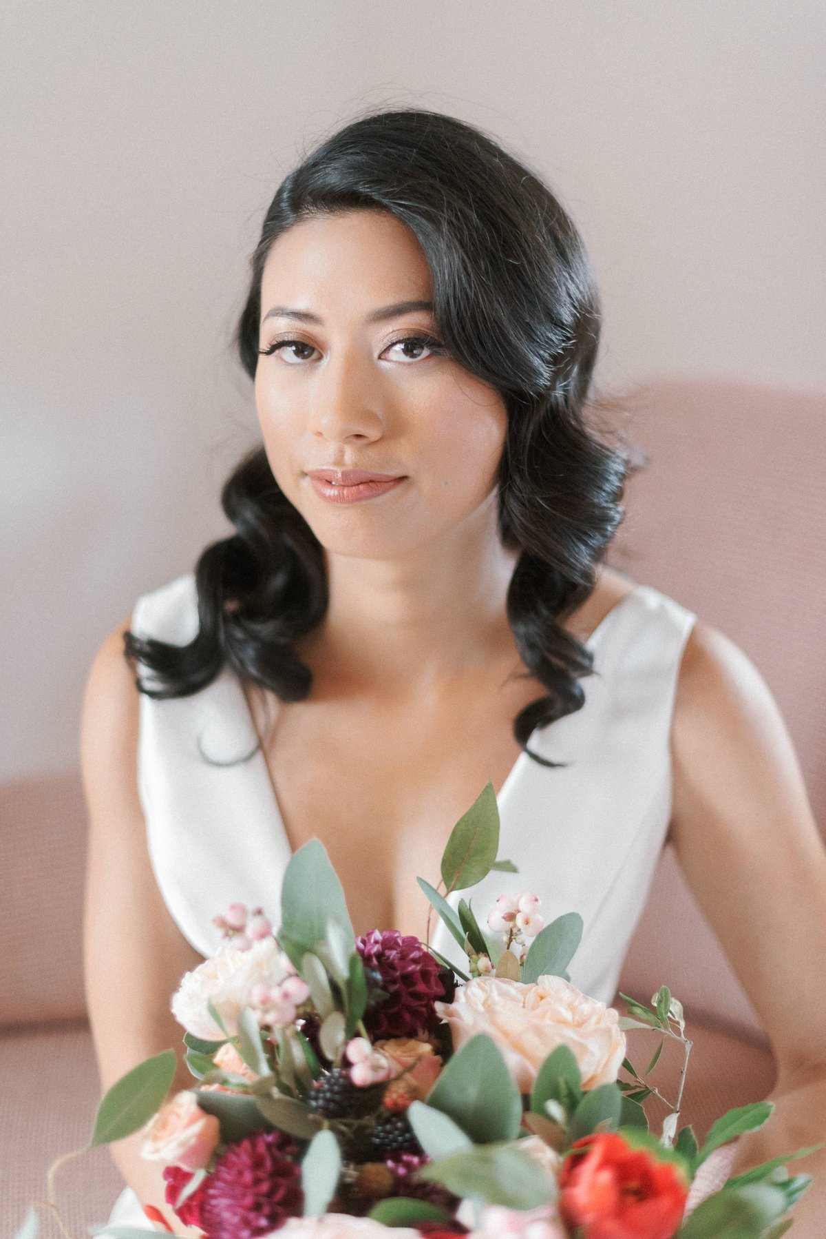 bride holding her moody wedding bouquet