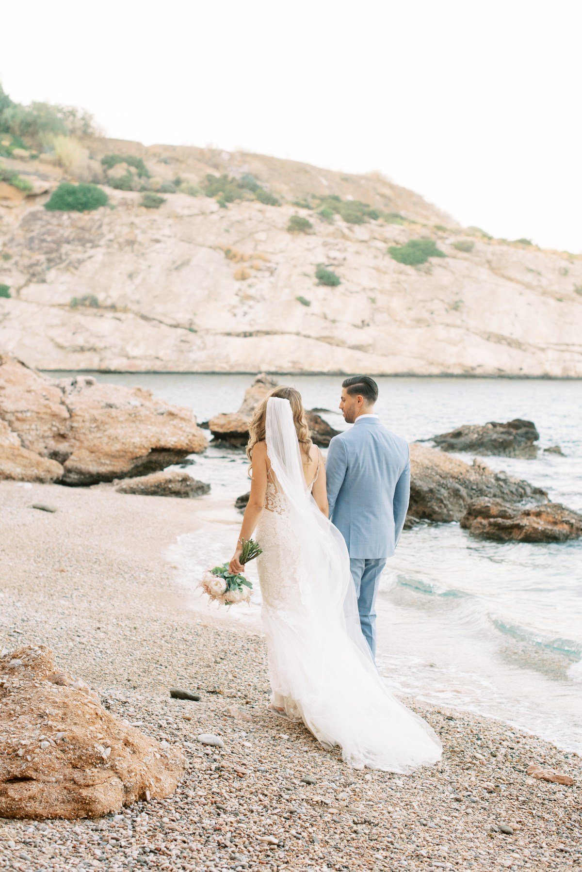 couple-walking-on-the-beach-destination-wedding-in-the-athenian-riviera-les-anagnou