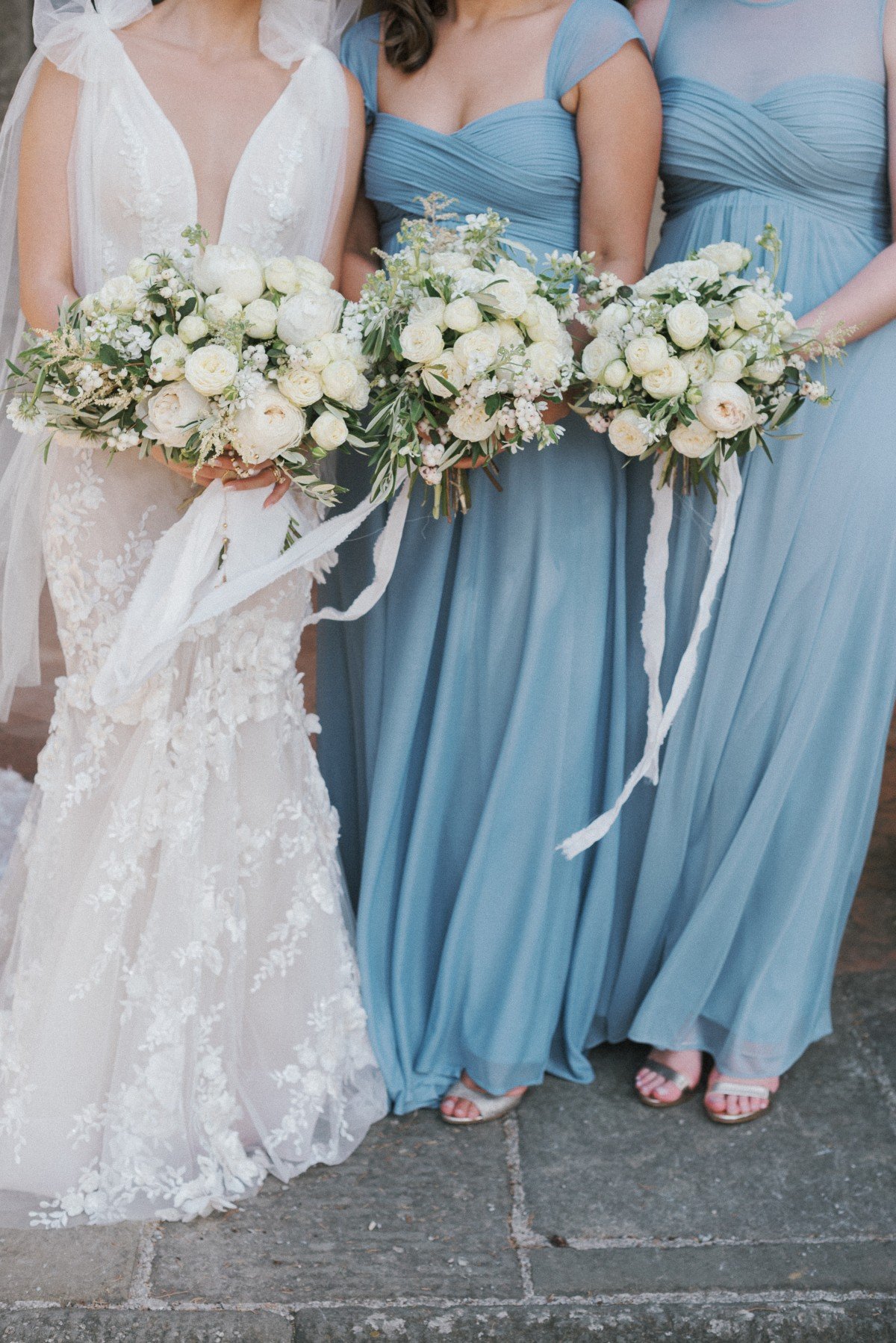 bride and bridesmaids in blue dresses by les anagnou