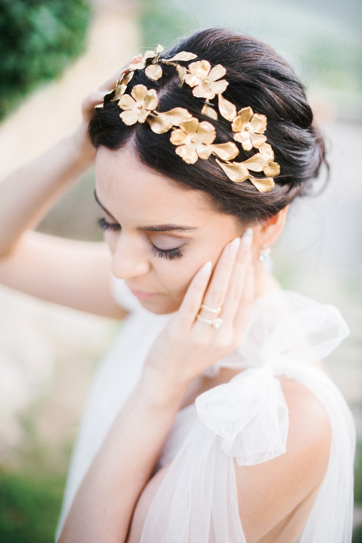 close up of bride wearing a gold headpiece