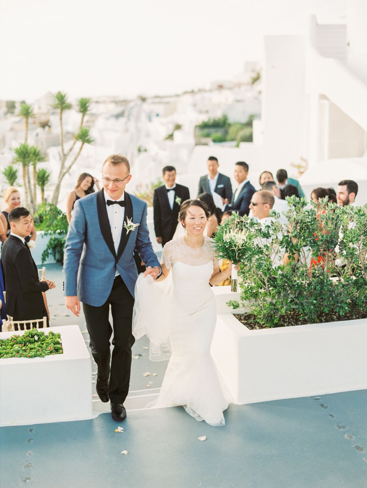 wedding photographer greece - plan a destination wedding in three months - couple leaving the altar in Santorini